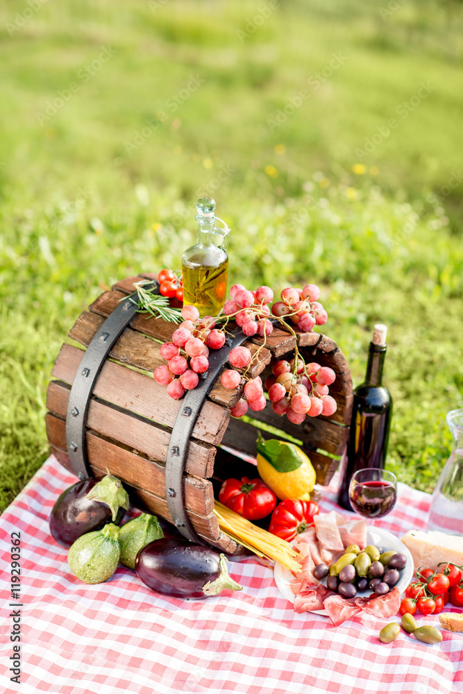 Lots of tasty italian food on the napkin and wooden barrel outdoors