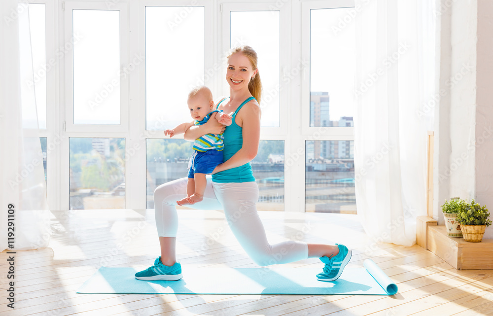 sports mother is engaged in fitness and yoga with baby at home