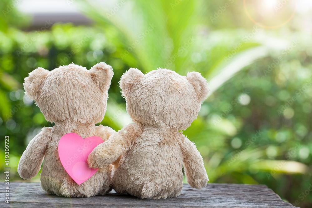 Valentines concept, Teddy bear with paper heart  on wooden natur