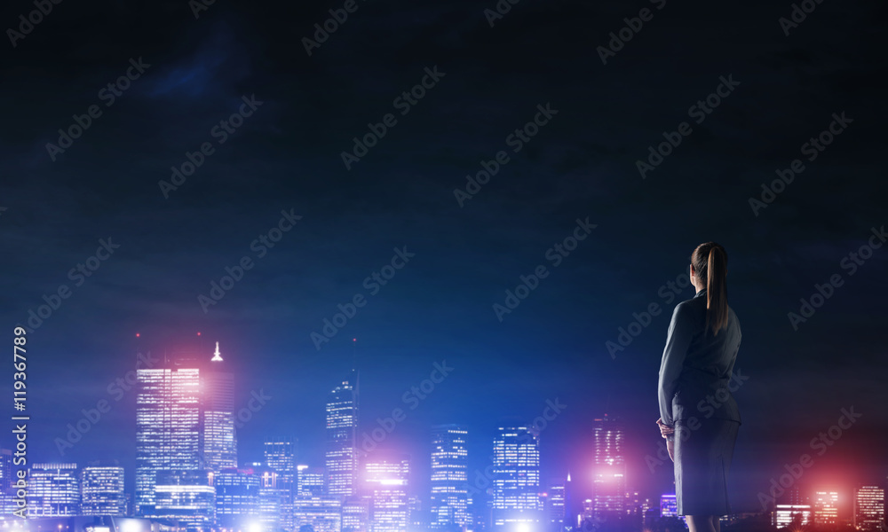 Woman looking at night city