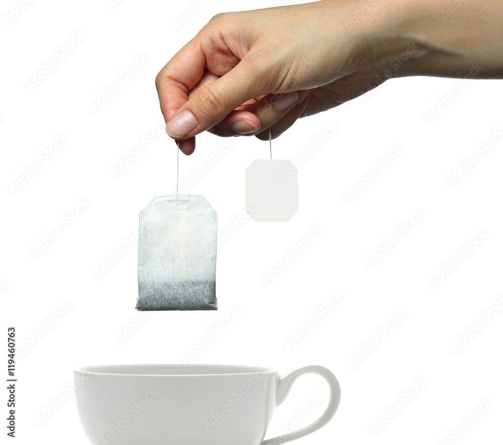 Womans hand holding tea bag isolated on white background