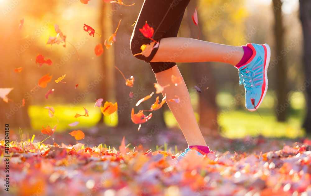 Close up of feet of a runner running in leaves