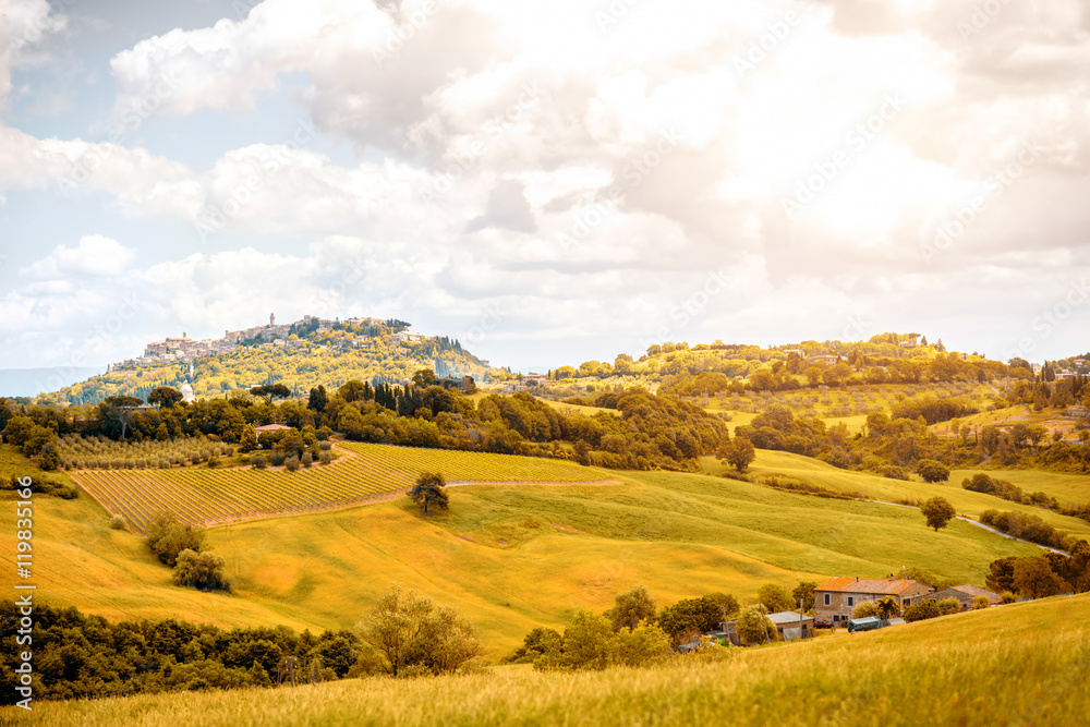 Beautiful tuscan landscape view on the green meadow with farmlands near Montepulciano town in Italy