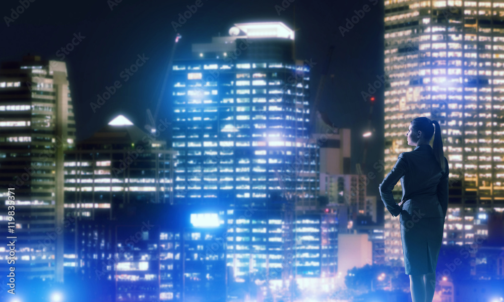 Woman looking at night city