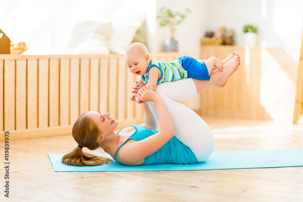 sports mother is engaged in fitness and yoga with baby at home