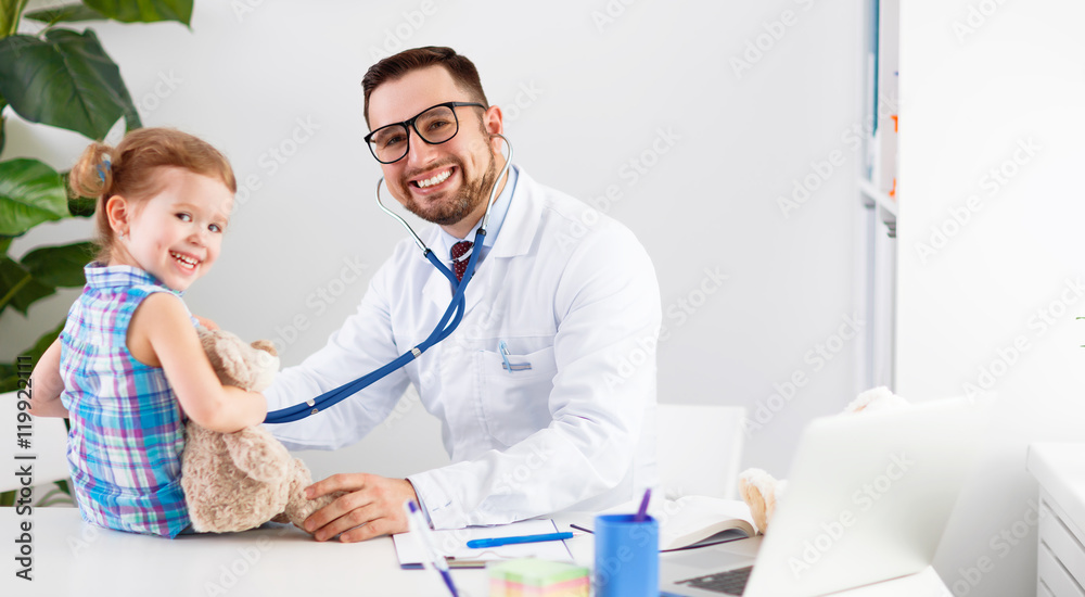 friendly happy male doctor pediatrician with patient child girl