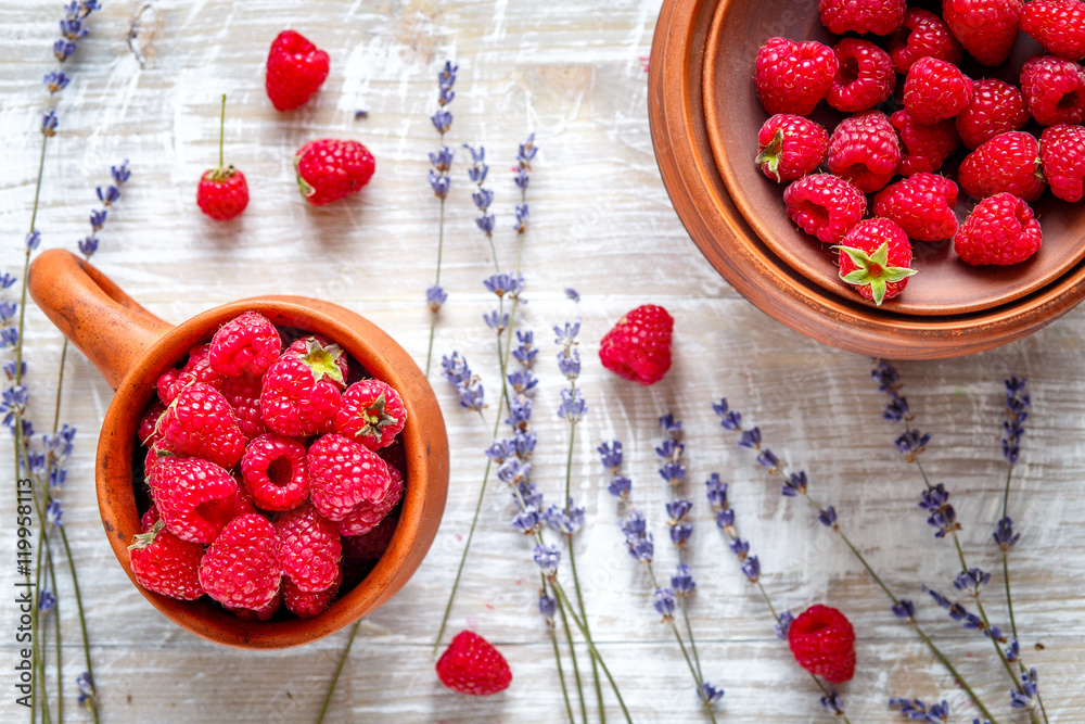 pottery with strawberries and lavender on wooden table