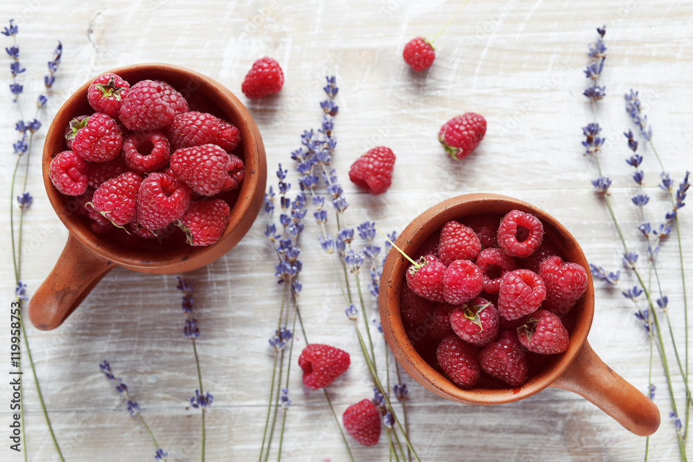 pottery with strawberries and lavender on wooden table