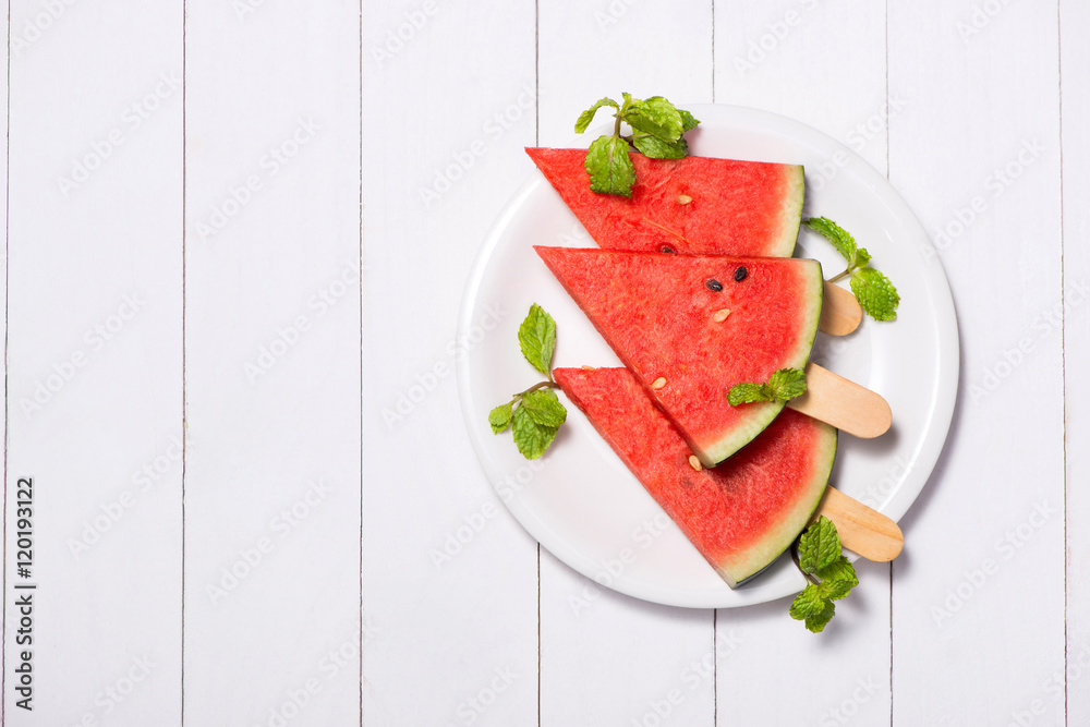 Watermelon slices on sticks. Watermelon popsicle on wooden white