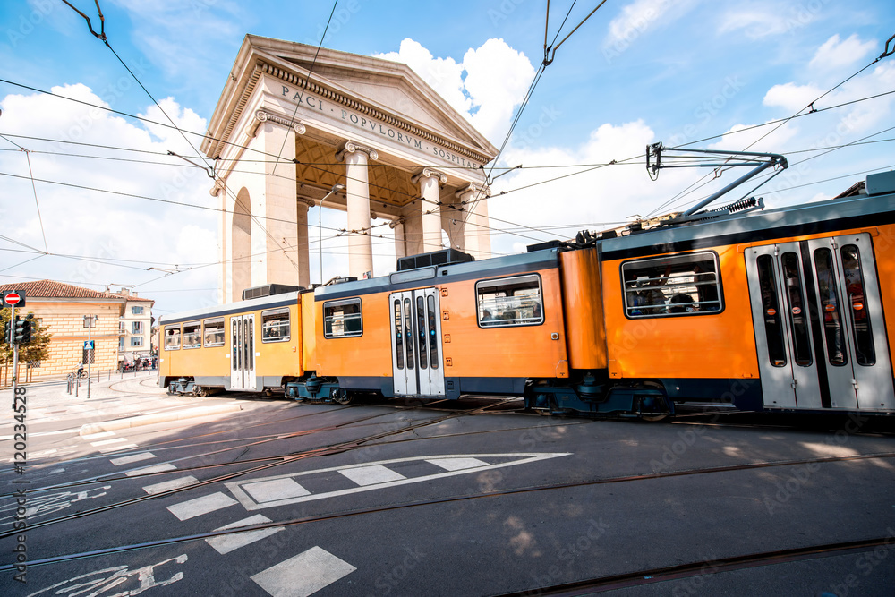 Street view on Ticinese city gate and tram in Milan