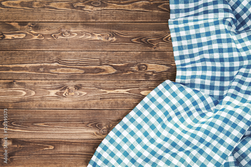 Blue checkered tablecloth on wooden table