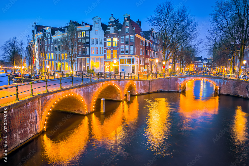 View of Canal House at night in Amsterdam, Netherlands