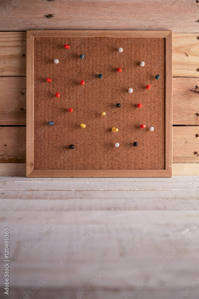 pinned on corkboard with old wooden texture background