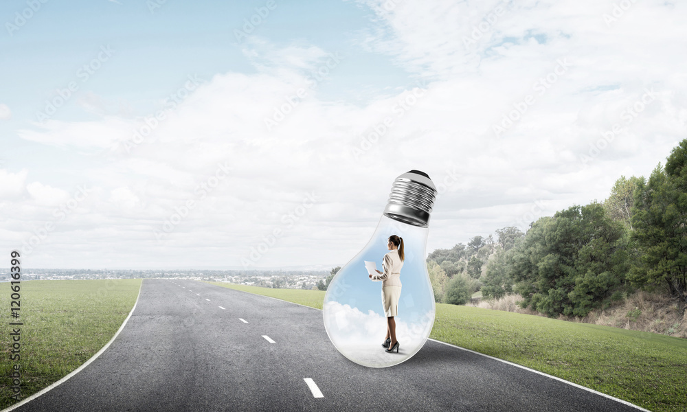 Businesswoman inside light bulb