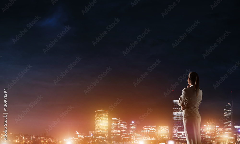 Woman looking at night city