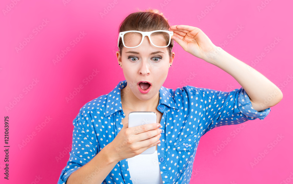 Young woman staring at her cellphone