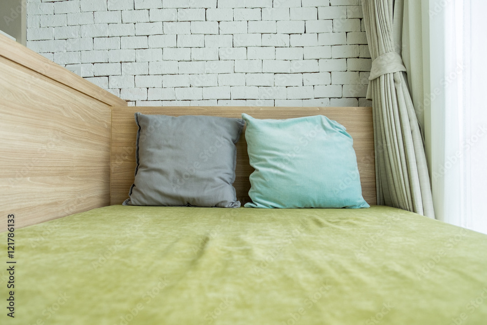 Green bed and colorful pillows