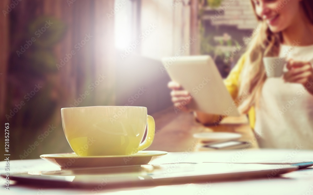 Composite image of cup of coffee and tablet pc