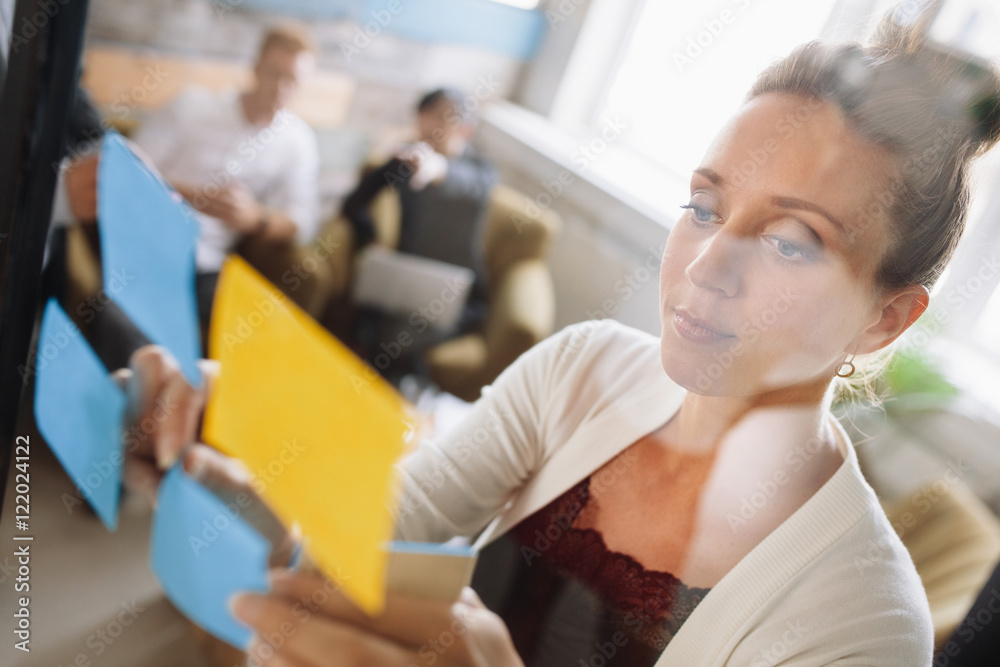 Woman presenting ideas to colleagues during meeting