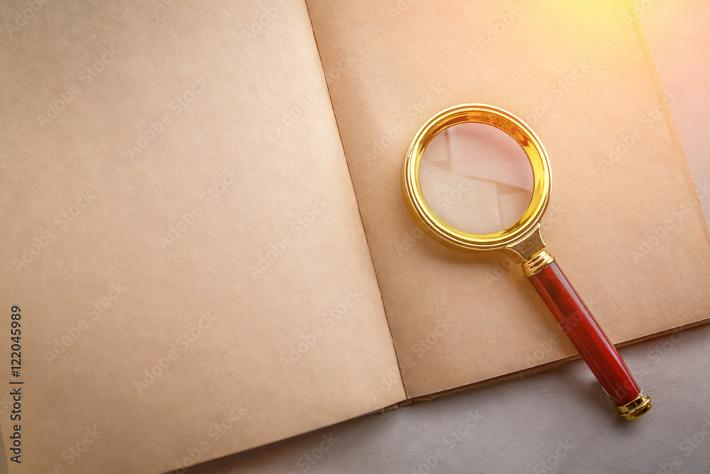 blank page notebook with a magnifying glass