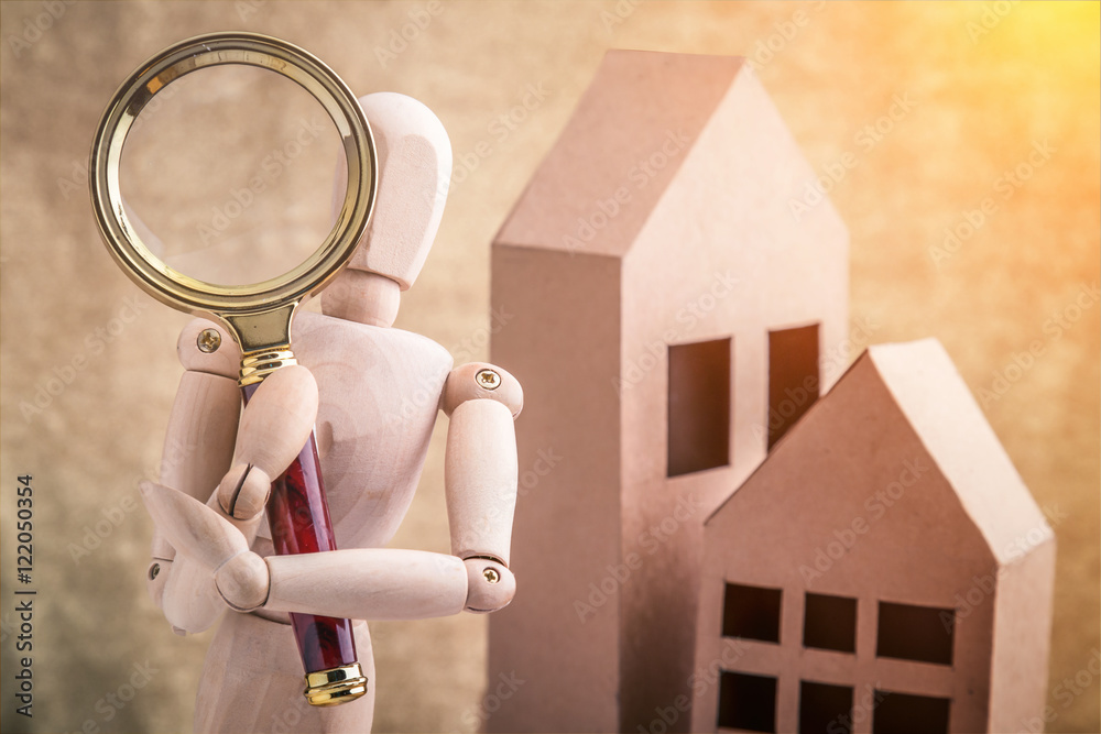 check a house concept wooden person with a magnifying glass