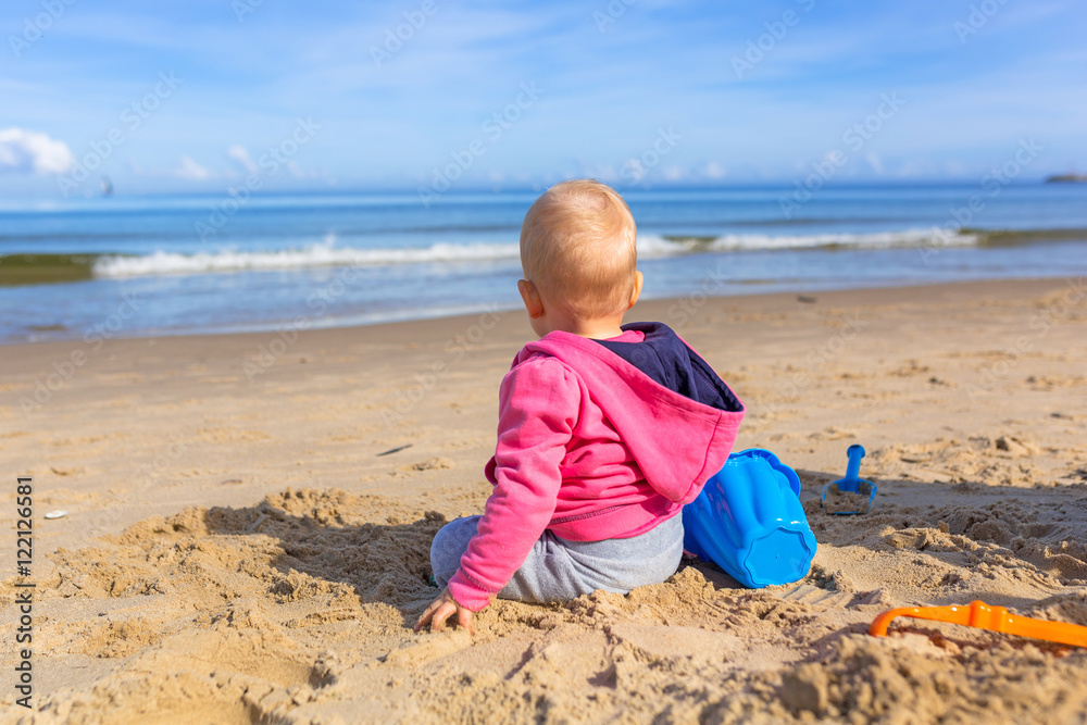 Little girl on the beach of Baltic Sea in Poland