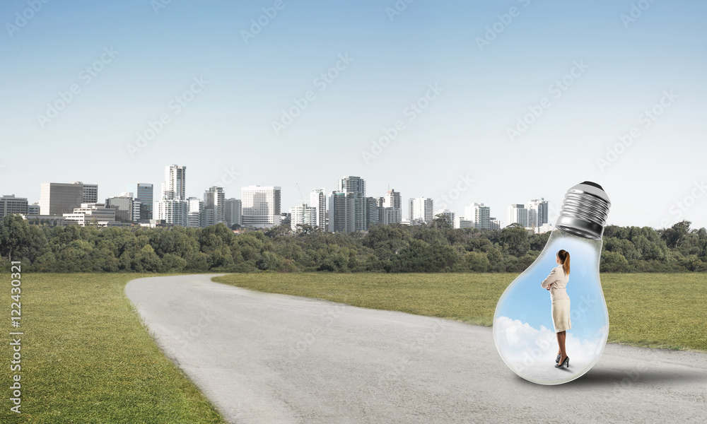 Businesswoman inside light bulb