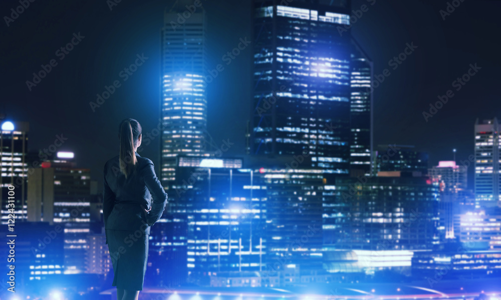 Woman looking at night city