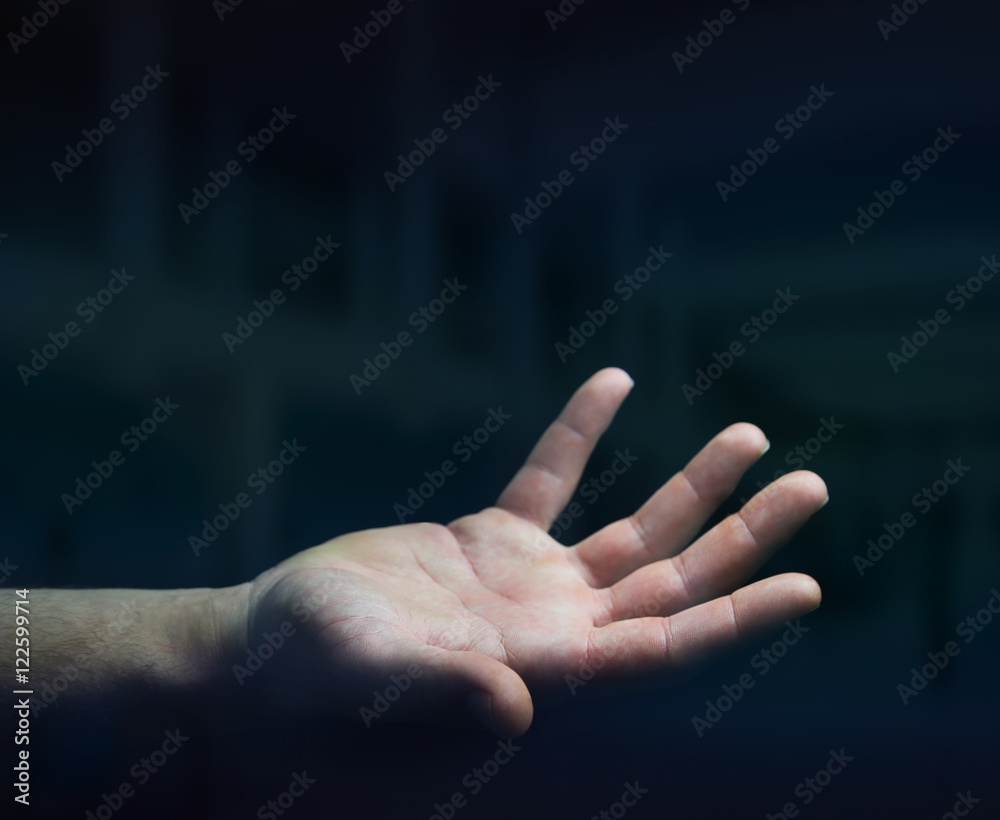 Businessman hand on black dark background