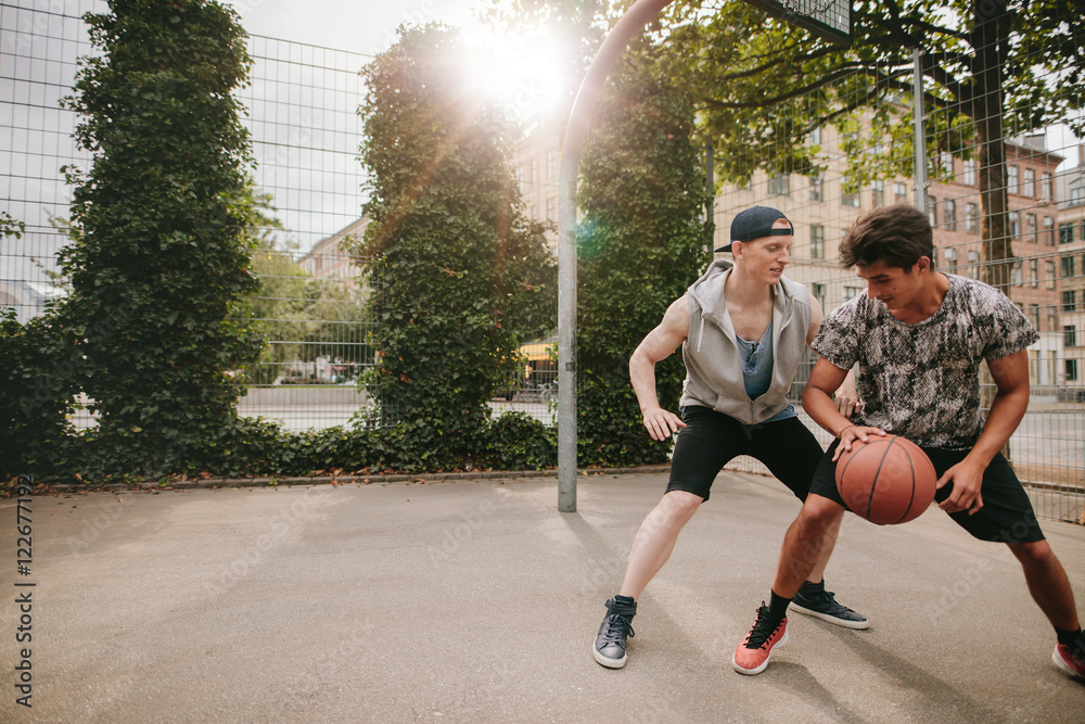 Young men playing a game of basketball