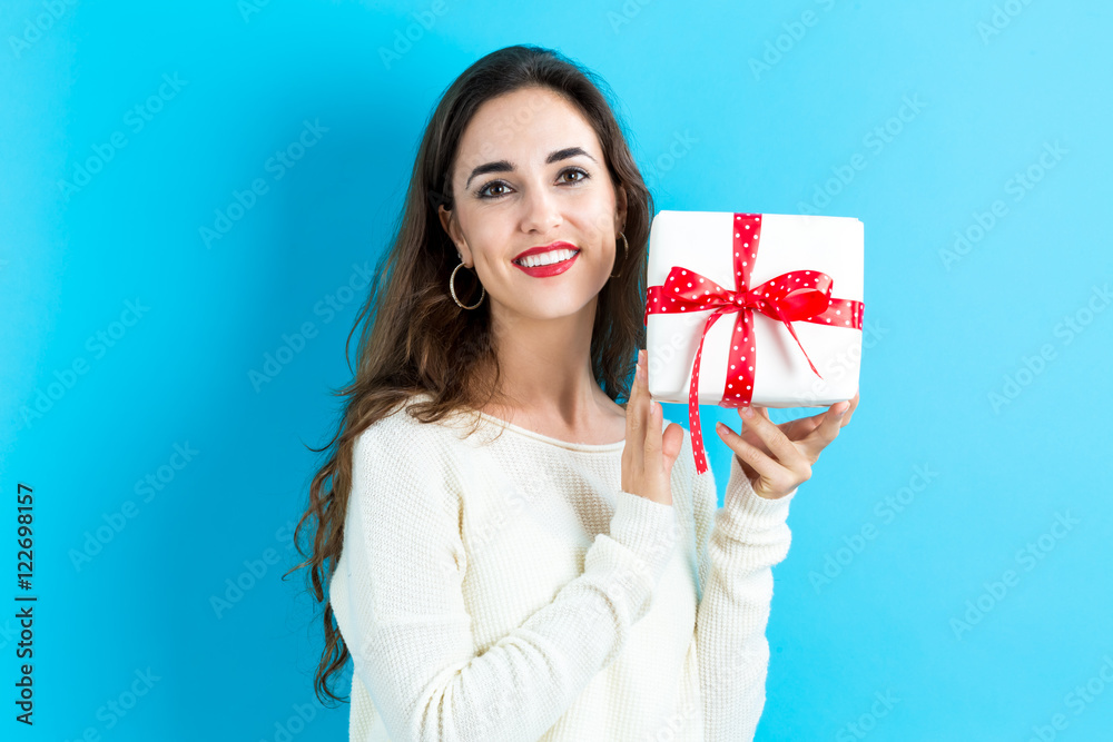 Young woman holding a gift box