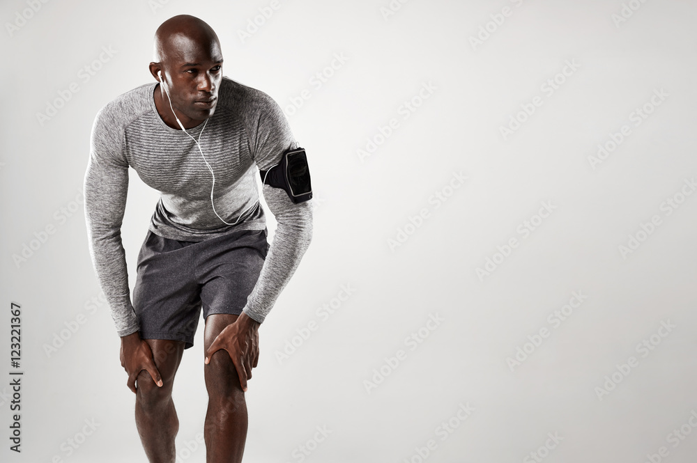 Muscular male model with armband and earphones