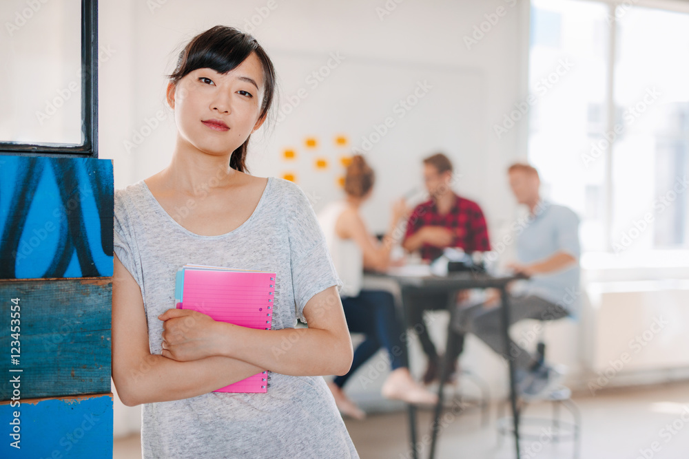 Young asian business woman standing in office