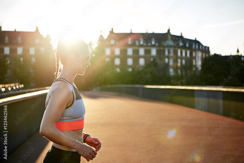 Woman in athletic wear exercising outdoors