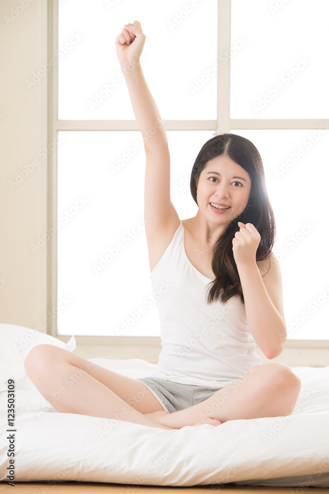 beautiful asian woman feel success awake sitting on bed