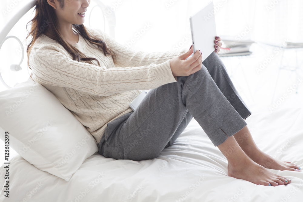 Women have a video phone on the tablet in bed