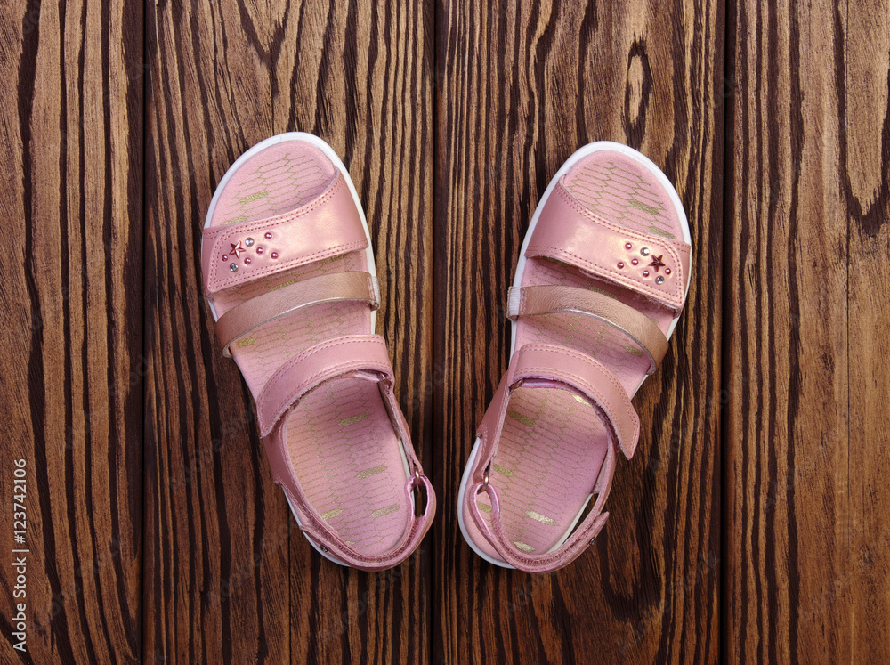 Childs sandals on a wood