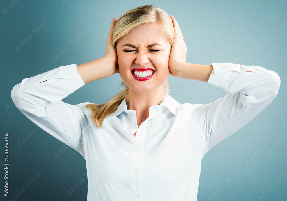 Young woman blocking her ears