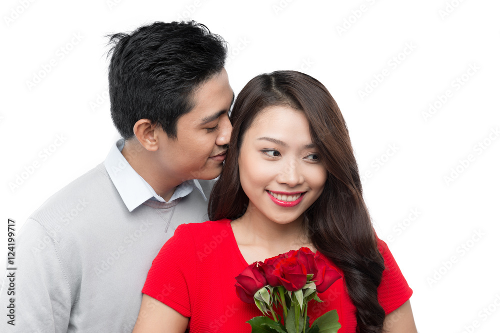 young man giving his girlfriend a rose and kissing celebrating v