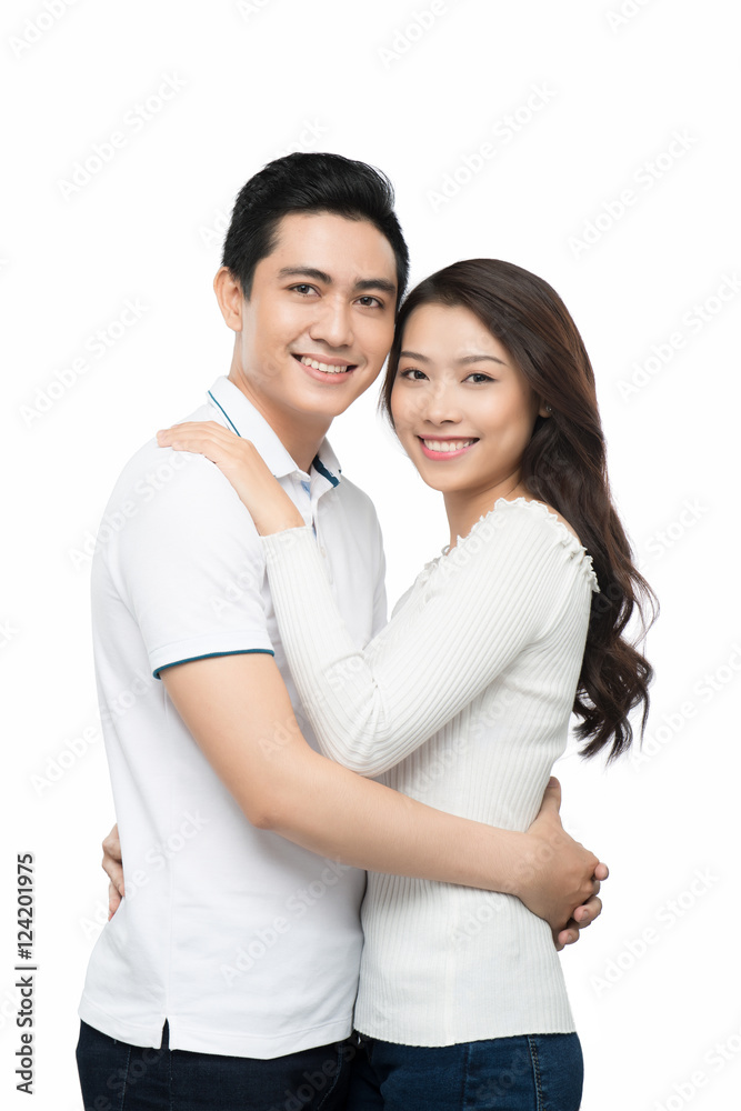 Happy couple hugging and kissing over white background