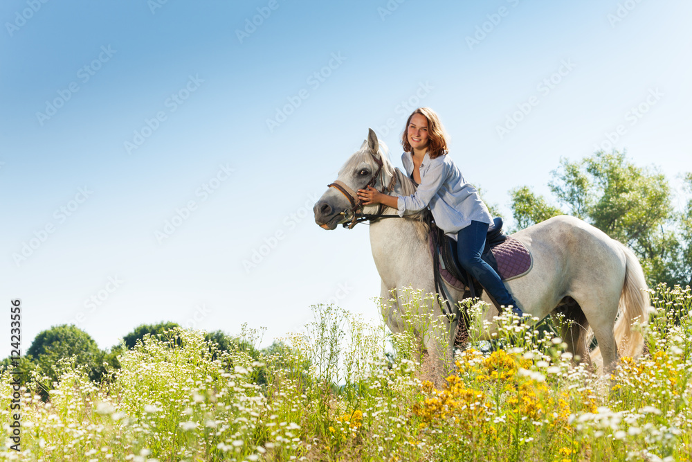 Portrait of beautiful woman hugging white horse