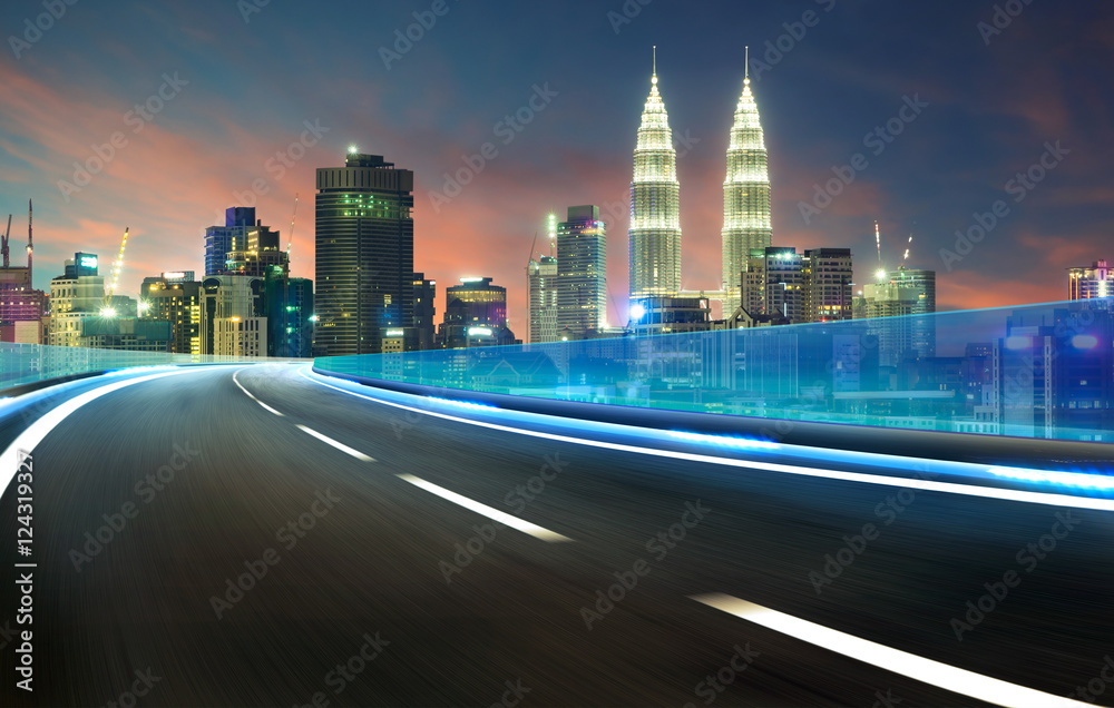 Blue neon light highway overpass motion blur with city  skyline background , night scene .