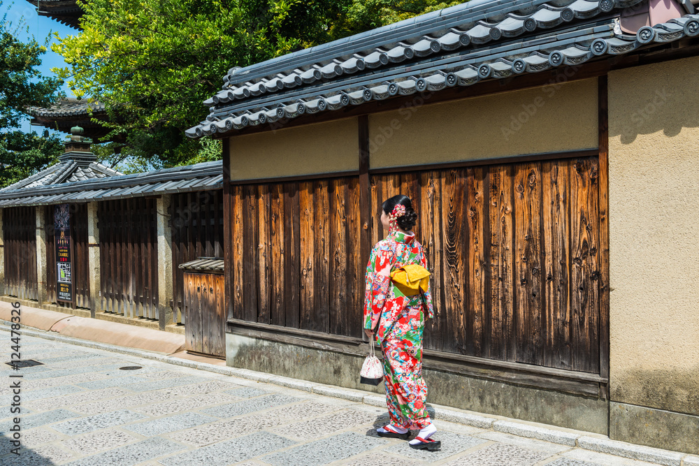 穿着和服的亚洲女人走在日本京都的老街上