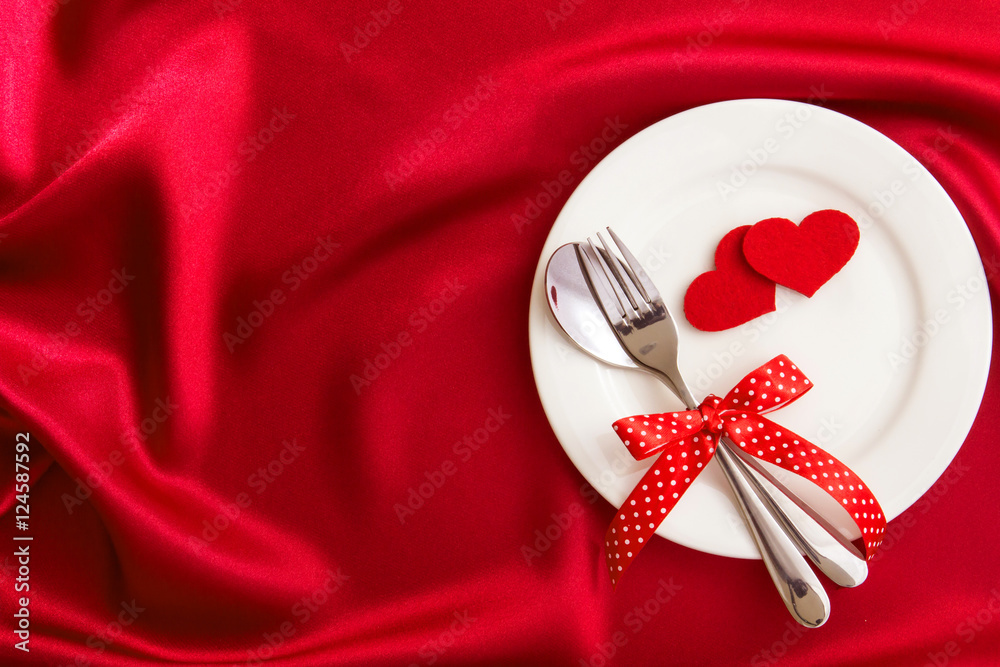 red heart shape with White empty plate with fork and spoon 