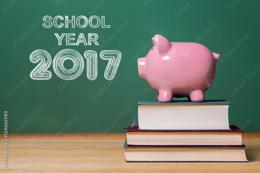 School Year 2017 text with pink piggy bank on top of books