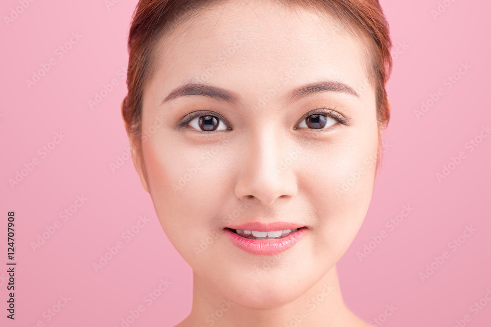 Close up beautiful young Woman face on pink.