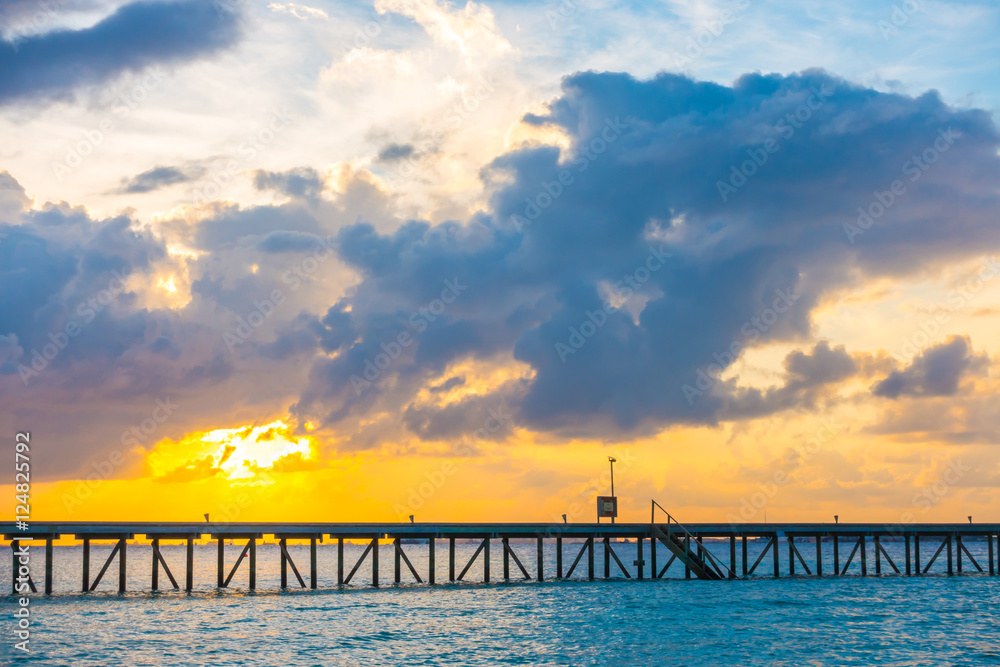 Beautiful sunrise with  water villas  in tropical Maldives islan