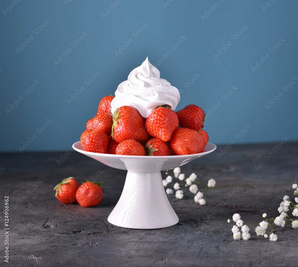 Fresh strawberries with whipped cream, frozen yogurt on a dark background