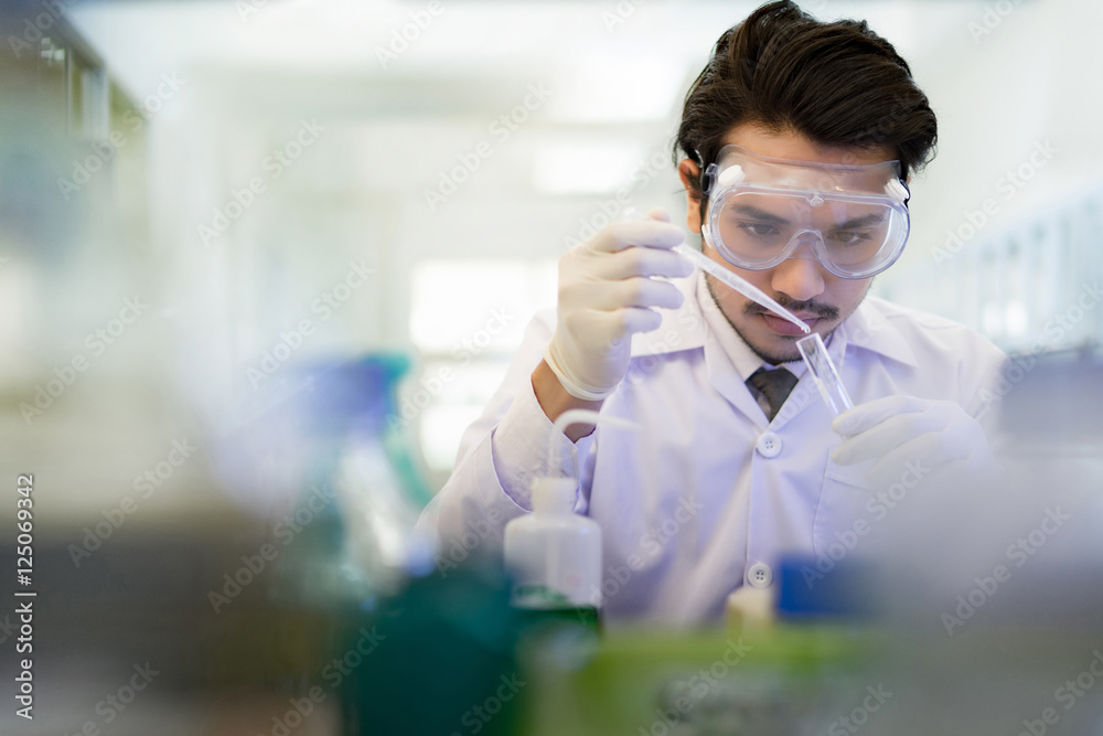 Asian scientist  in the laboratory working at lab with test tube