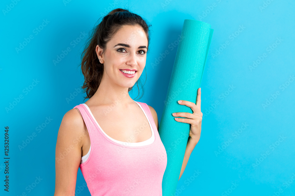 Woman holding yoga mat